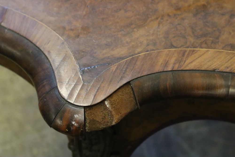 A Victorian figured walnut centre table of serpentine form, with ormolu mounted cabriole legs, width 130cm, depth 89cm, height 74cm